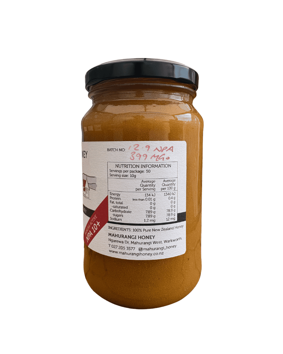 A glass jar of Mauburangi Honey with a black lid and a white label, shown against a plain white background. The honey inside is a rich amber-brown color, and there is a red promotional sticker on the left side of the label.